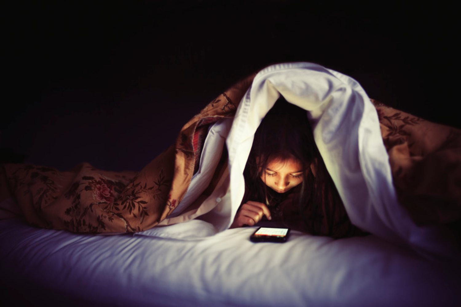 Девушка в постели под одеялом