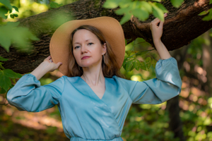 В тени деревьев.