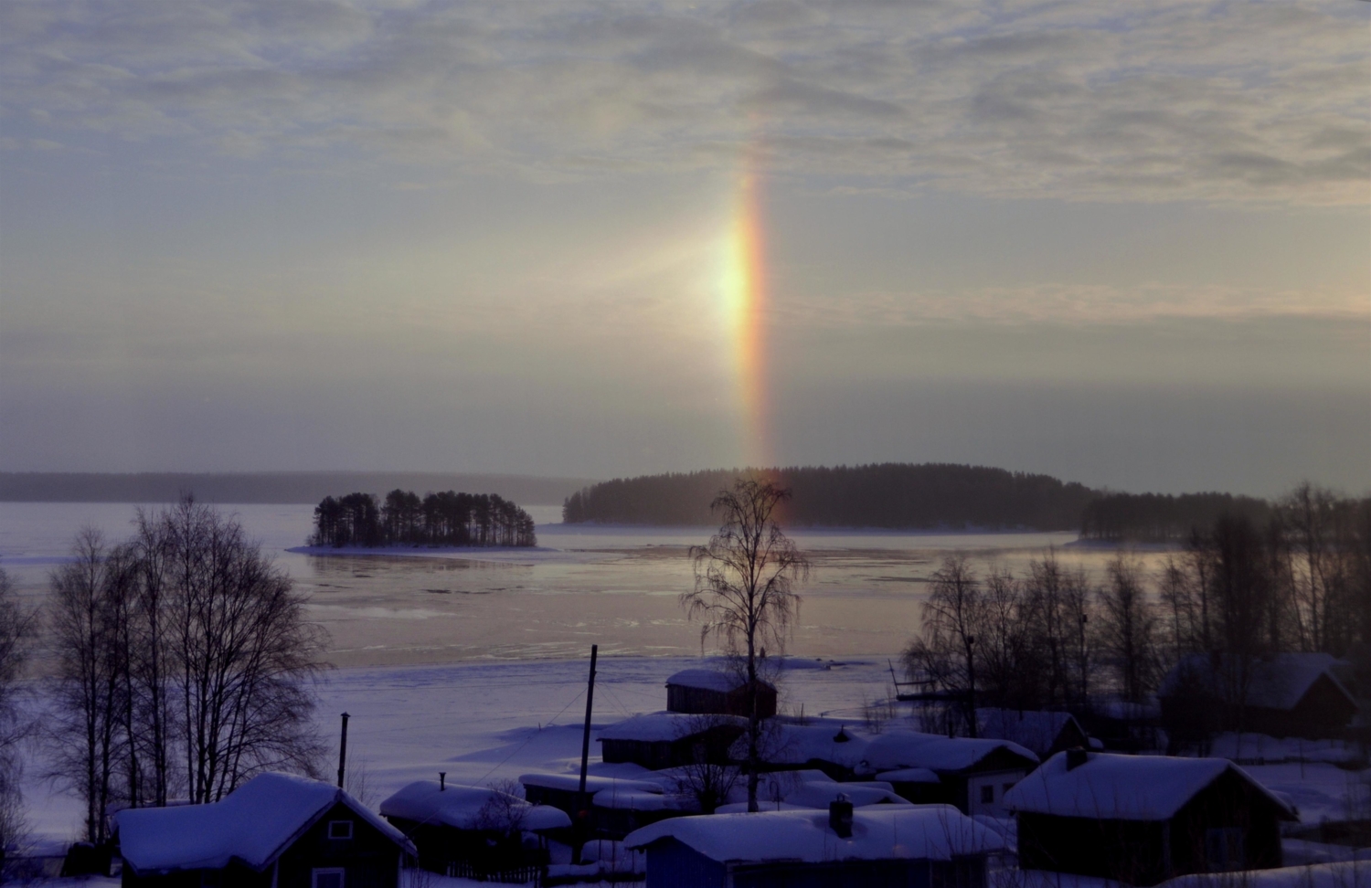 The winter rainbow over the lake