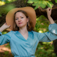 В тени деревьев.